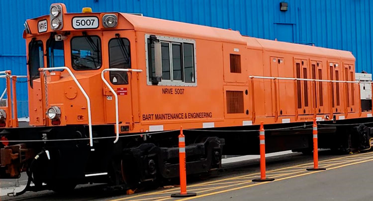 A 14-railcar maintenance train sits in a railyard.