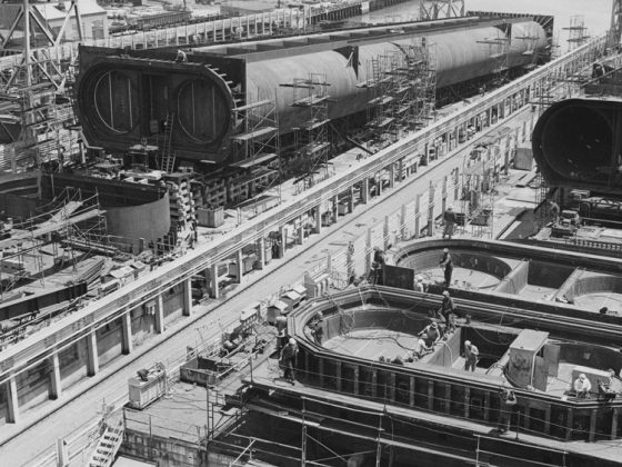 Black and white image of a construction yard with sections of the Bay Area Rapid Transit Transbay Tube.