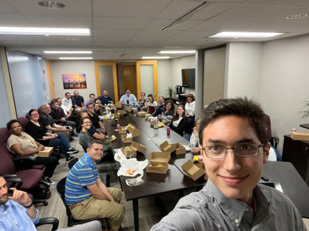 A group of people sitting at tables enjoying lunch.