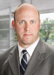 Professional geologist is wearing a light brown suit and tie.
