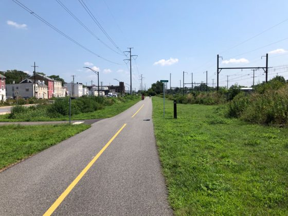 A walking and biking path on Lafayette Street with buildings in the background.