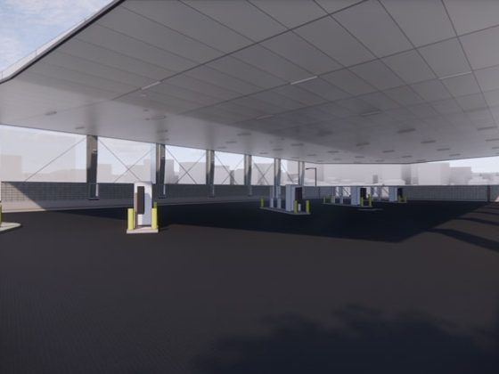 from inside a battery electric bus charging station building with four charging stations.