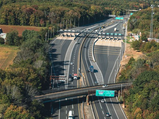 Aerial view of a toll interchange on a sunny day.