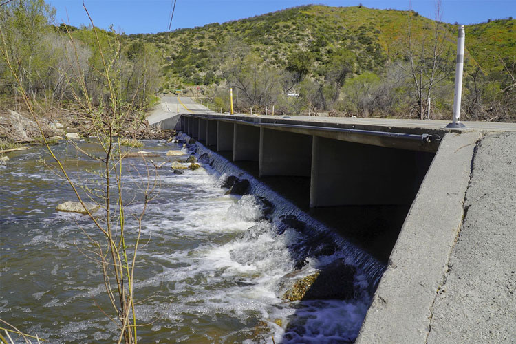 A side view of the Sandia Creek Bridge over Santa Margarita River on a sunny day.