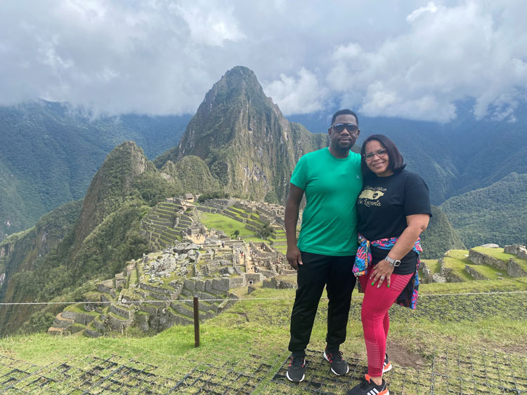 Steve and his wife pose for a picture while traveling the world.