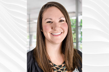 Caucasian female smiles for a professional portrait.