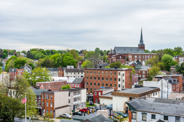 Aerial of historic downtown Lancaster, Pennsylvania, with blooming trees and brick buildings.